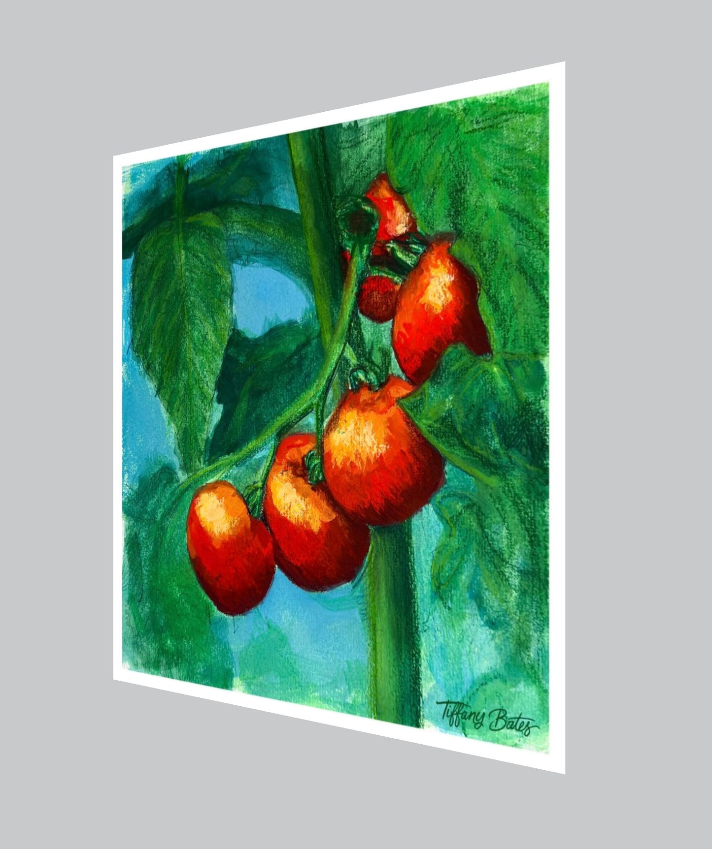 Angled view of Fine art print of gouache painting depicting red tomatoes on a vine with green leaves.