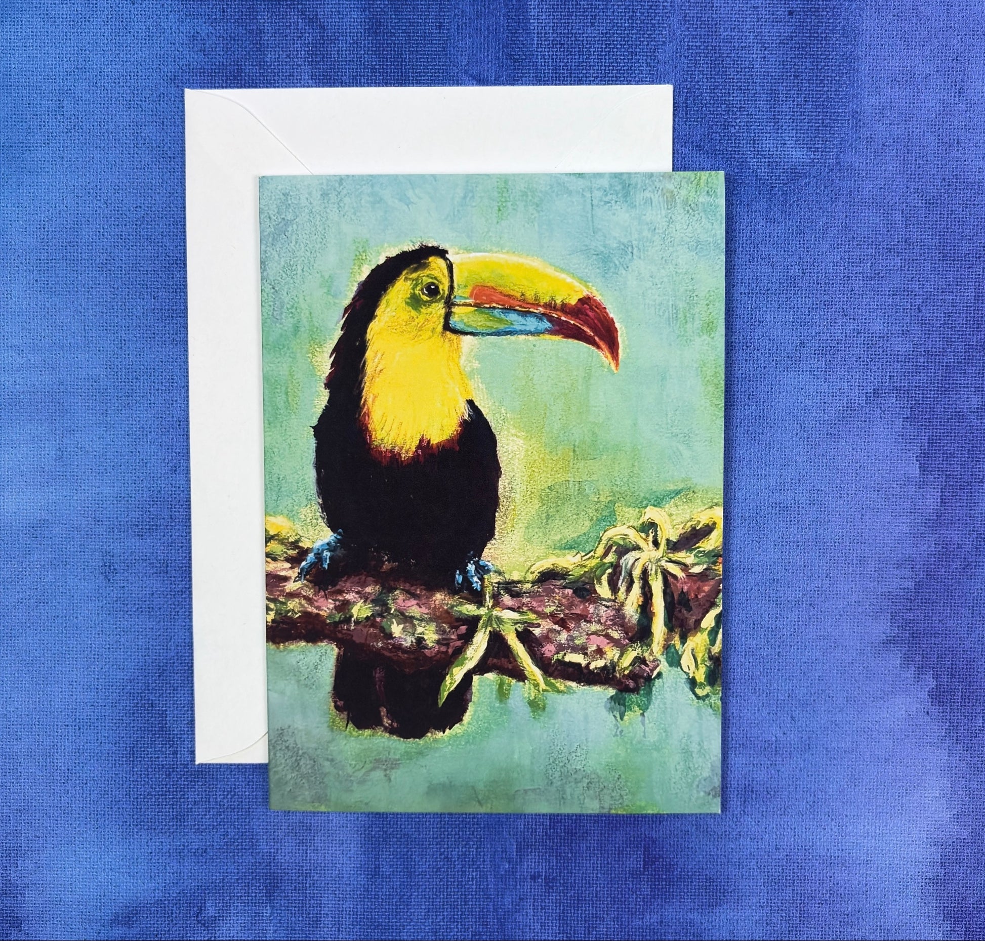 Greeting Card with a toucan painting with a green background on a blue and purple background