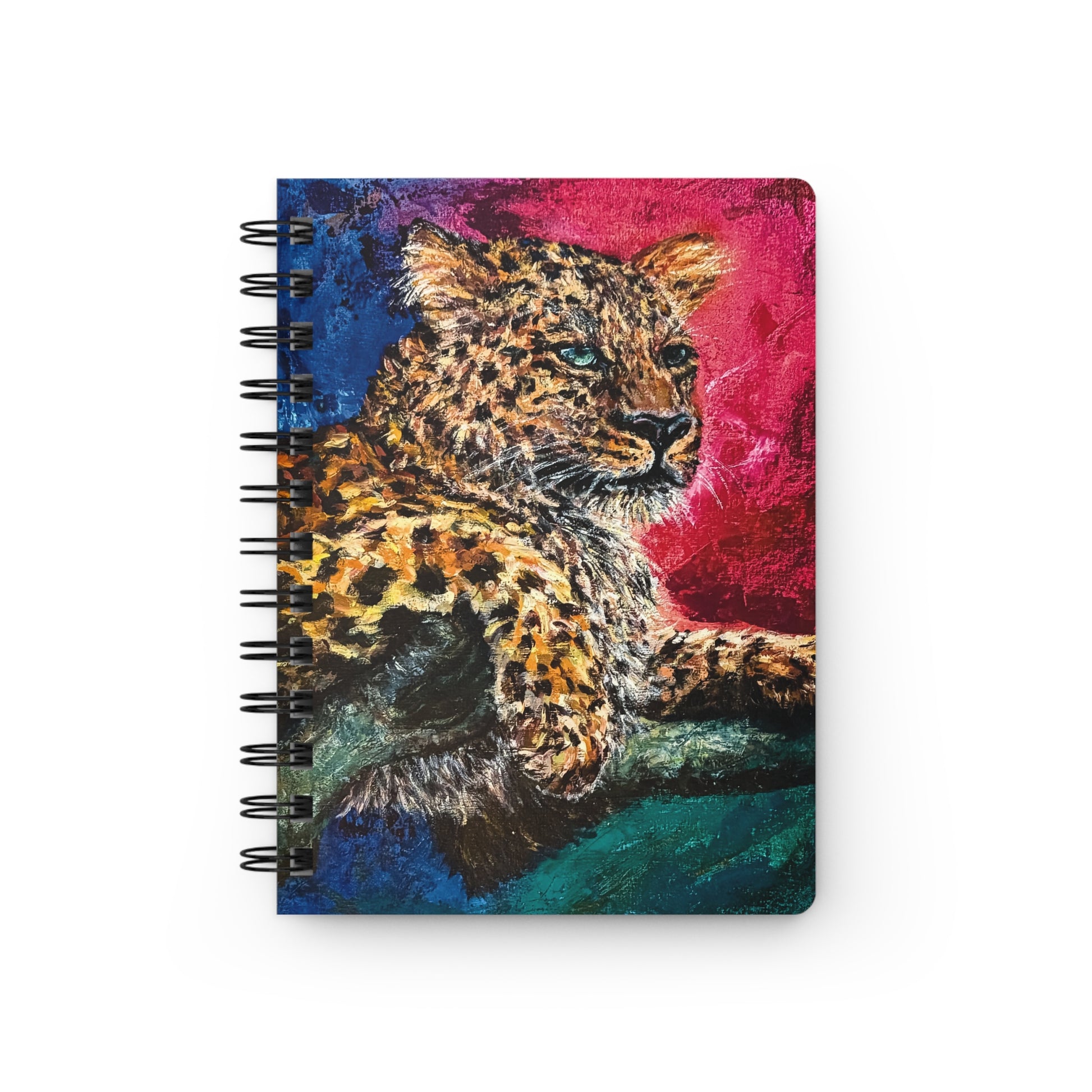 A spiral notebook with a painting of a jaguar with rich pinks greens and blues.