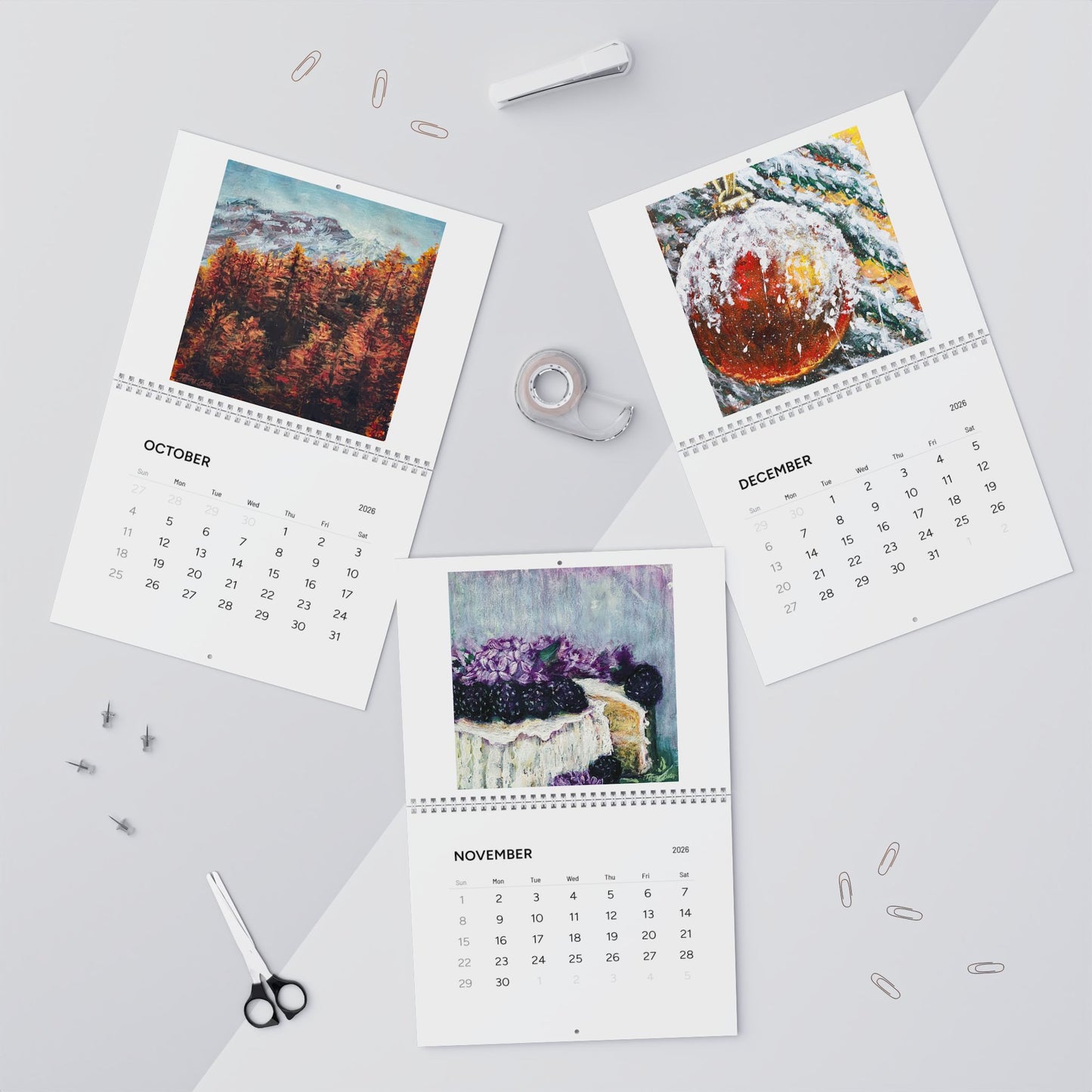 Three calendar pages for October, November, and December on a light gray background with stationery items.