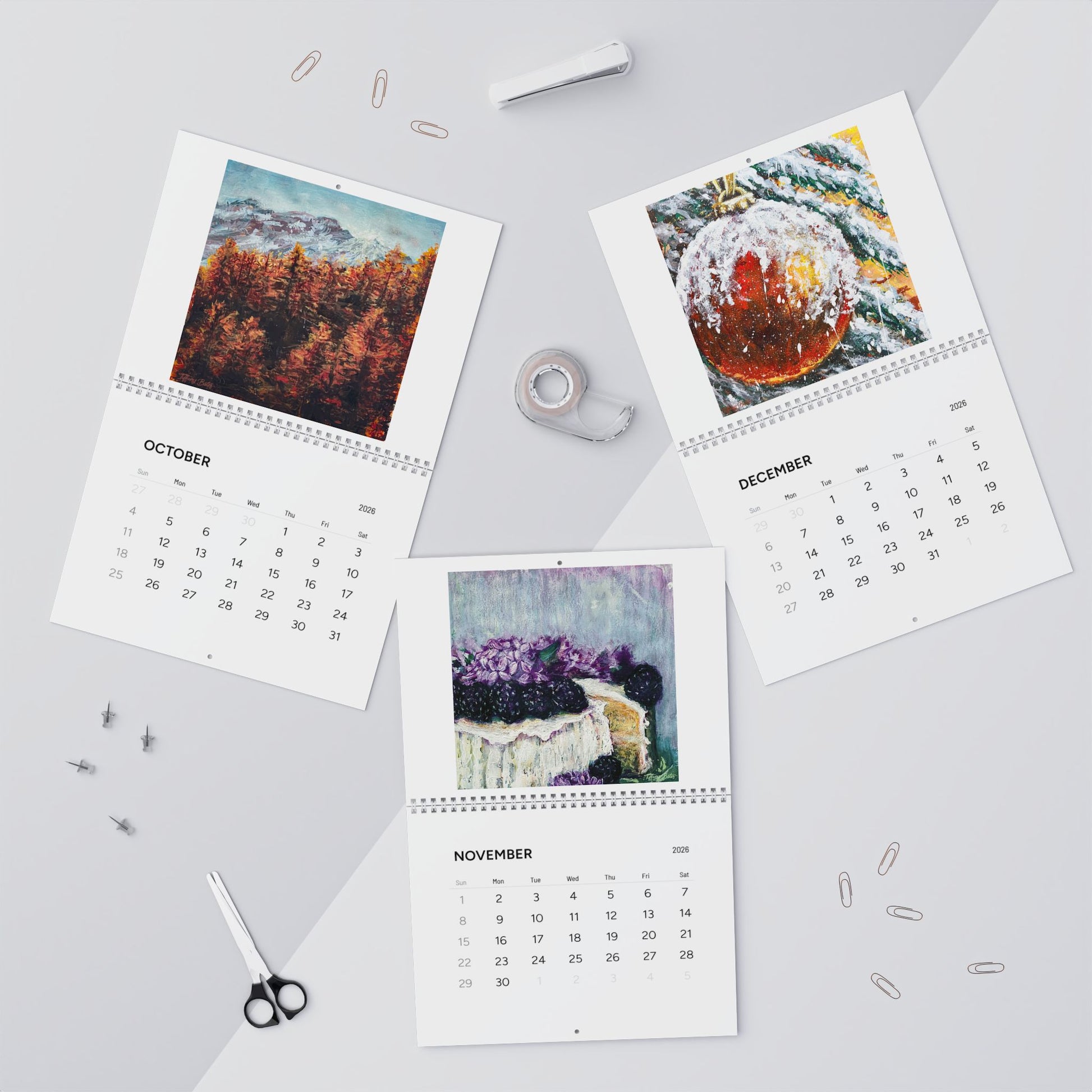 Three calendar pages for October, November, and December on a light gray background with stationery items.