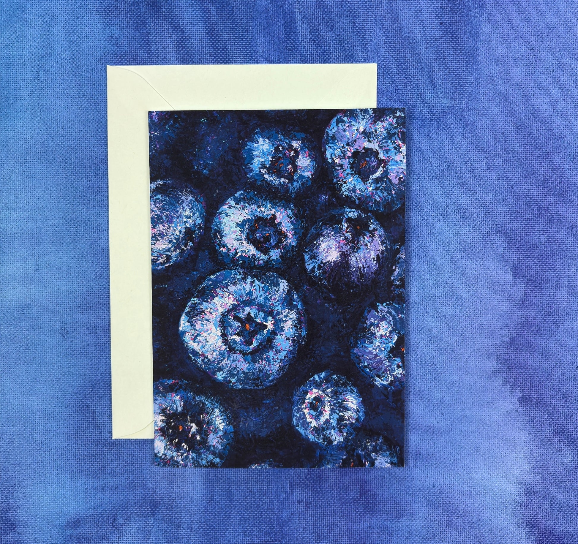 Greeting Card with vibrant blueberry painting on a blue fabric background